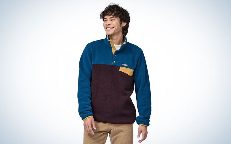 A person wearing Patagonia's Synchilla pull-over fleece on a plain background